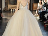 a wedding ballgown with a white lace bodice on straps and a full layered skirt plus a plunging neckline
