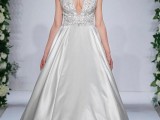 an A-line wedding dress with a lace embellished bodice with a plunging neckline and a plain maxi skirt