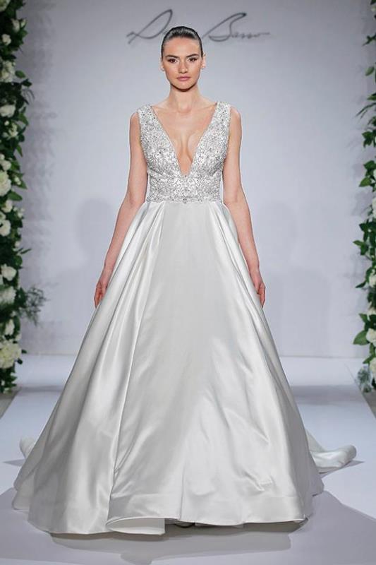 An A line wedding dress with a lace embellished bodice with a plunging neckline and a plain maxi skirt