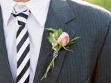 a graphite grey thin stripe suit, a white shirt and a striped black and white tie, a peachy pink flower boutonniere are a nice combo for a wedding