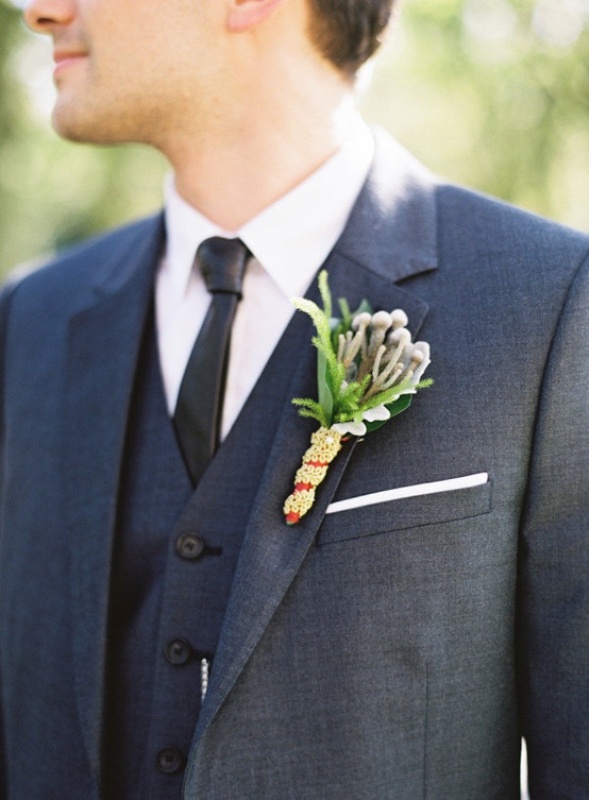 a graphite grey three piece pantsuit, a white shirt, a black skinny tie and a textural boutonniere are a cool and bold combo to rock
