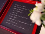 chalkboard seating charts in red frames are a fun and cool idea for a modern wedding