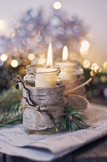 jars wrapped with bark and evergreens and with candles inside look super cool and super cozy