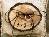 a wood burnt ring holder with twine is a nice alternative to a usual ring pillow and fits a rustic wedding