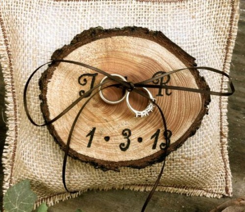 a wood burnt ring holder with twine is a nice alternative to a usual ring pillow and fits a rustic wedding