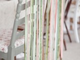 mismatching chairs with various pastel-colored ribbons on them look fun, chic and very spring-like