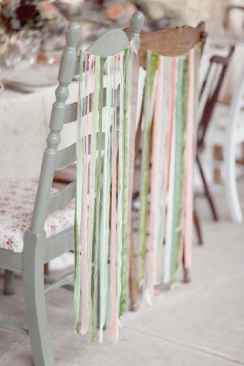 mismatching chairs with various pastel-colored ribbons on them look fun, chic and very spring-like
