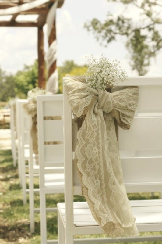 White chairs with burlap and lace decor and with baby's breath are amazing for a rustic space, they will add elegance to it