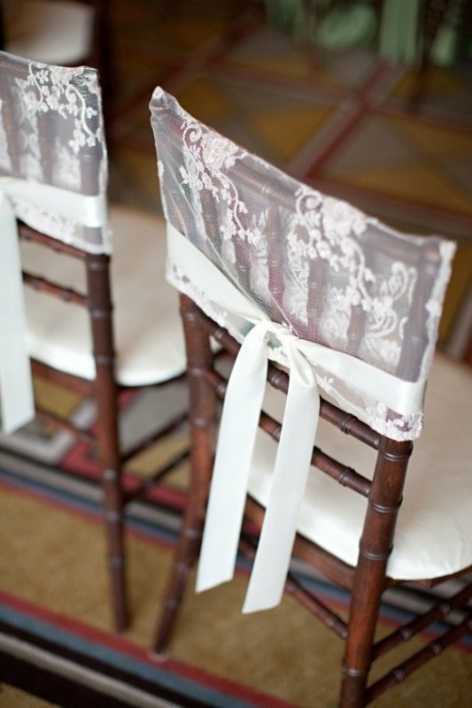 Stained chairs with white lace covers and ribbons look chic, vintage like and elegant