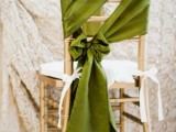 a gold chair accented with beautiful green cover, with a bow and little white bows is a lovely idea for a wedding with greens