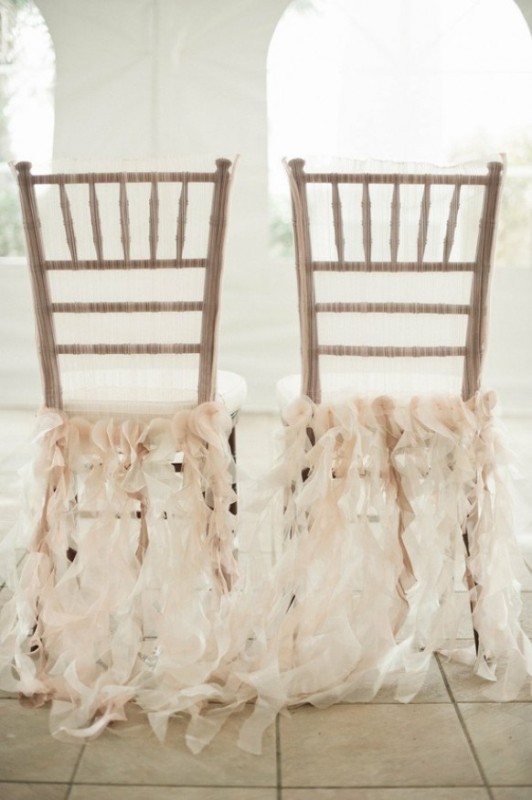 Gold chairs accented with blush ruffle ribbons look very stylish, chic and dreamy and add a romantic touch to the space