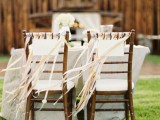 chairs decorated with white and yellow breezing ribbons add a light party feel to the space and make your reception more festive