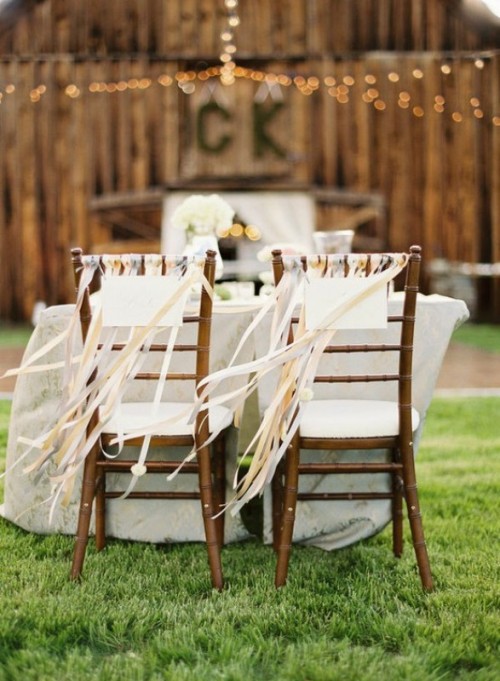 chairs decorated with white and yellow breezing ribbons add a light party feel to the space and make your reception more festive