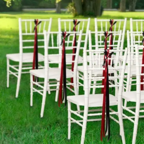 white chairs with black and red ribbon are amazing for wedding ceremony space decor and can do for a wedding reception, too