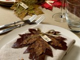 a fall seating card made of several fall leaves attached to each other is a great idea for a fall wedding