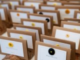wood logs with cardboard cards and colorful buttons are lovely for fall wedding escort cards, especially if it’s a wooden one