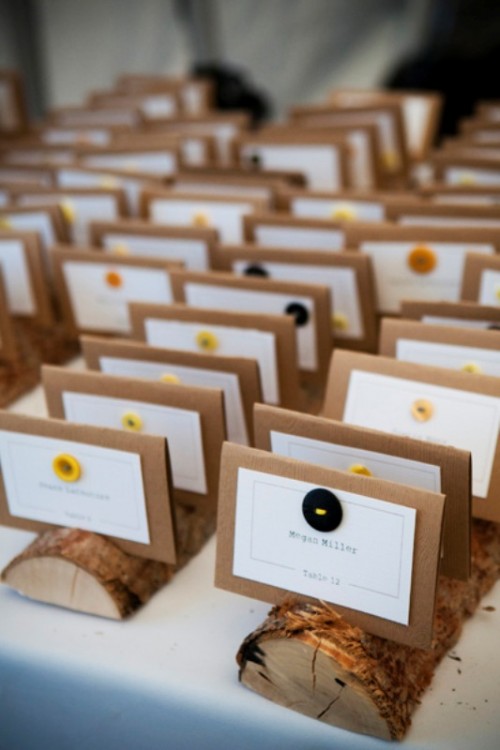wood logs with cardboard cards and colorful buttons are lovely for fall wedding escort cards, especially if it's a wooden one