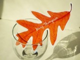 a bright fall leaf as a seating card is a cool and easy idea for a modern fall wedding