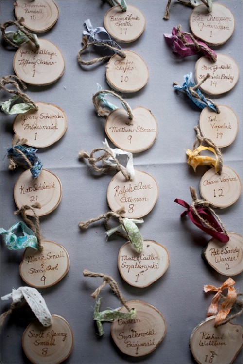 wood slices with burnt names, twine and colorful fabric are nice as fall escort cards