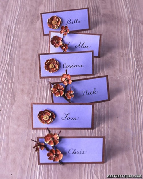purple framed cards with rust-colored brooches are lovely fall wedding escort cards you can rock at the wedding