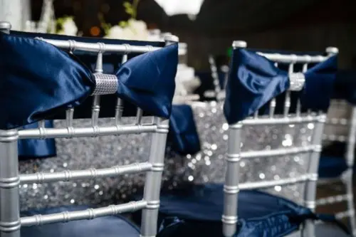 silver chairs with silk navy bows and embellishments will perfectly complete your tablescape look