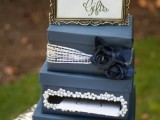a navy and silver card box with fabric blooms, shiny ribbons and embellishments