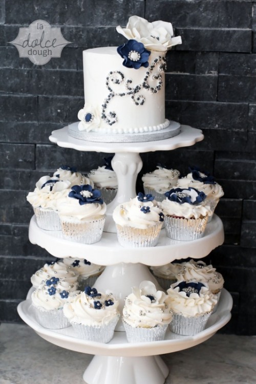 a stand with silver and navy cupcakes and a matching cake decorated with edible beads is a gorgeous idea