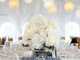 a neutral tablescape with white blooms and a catchy navy and white table runner