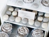 a dessert table with silver sweets – macarons, cupcakes and candies is ideal for a silver and navy wedding