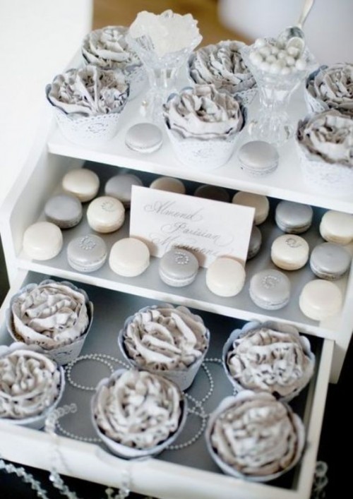 a dessert table with silver sweets - macarons, cupcakes and candies is ideal for a silver and navy wedding
