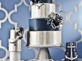 an assortment of navy and silver wedding cakes with striped and sleek tiers, sugar blooms and anchors for a nautical wedding