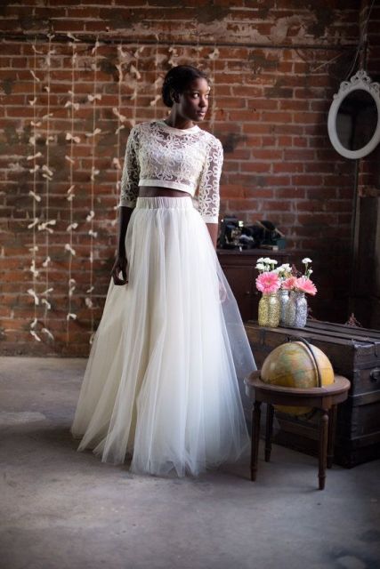 an elegant bridal look with a tulle maxi skirt and a boho lace crop top with long sleeves is a lovely and stylish idea for a modern wedding
