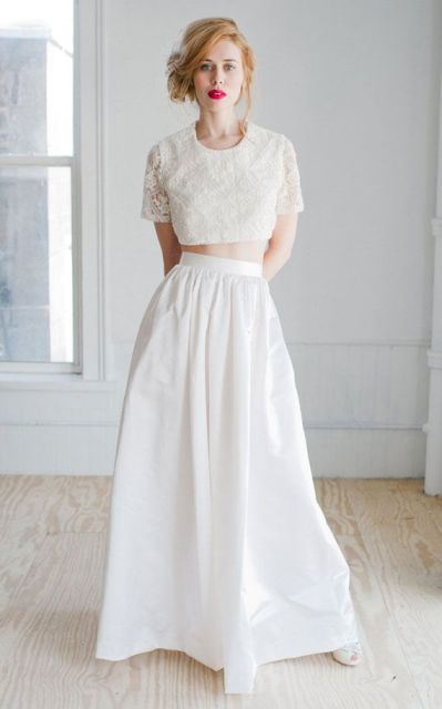 a delicate and chic bridal look with an applique crop top and a plain pleated skirt plus a red lip and neutral shoes and a messy hairstyle is chic