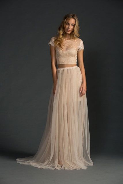a modern and chic wedding separate with a blush tulle skirt and an applique crop top with short sleeves is a lovely idea for a modern bride