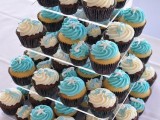 blue and white swirl cupcakes topped with edible seashells and starfish are great desserts for a blue beach wedding