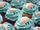 blue cupcakes topped with seashells are nice blue beach desserts