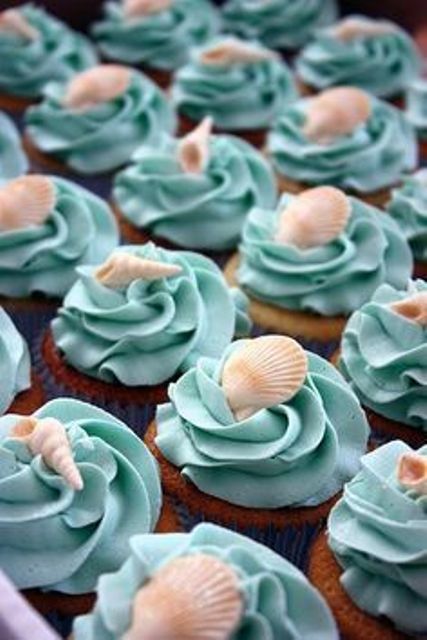 blue cupcakes topped with seashells are nice blue beach desserts