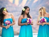 bright blue strapless bridesmaid maxi dresses with pleated skirts and draped bodices for a tropical beach wedding