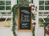 wedding decor with a chalkboard sign and calligraphy, greenery and blooms and lots of petals on the floor is amazing