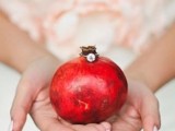 a pomegranate used to show off a wedding ring is a lovely idea for a fall or winter wedding with plenty of color