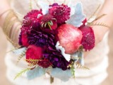 a bold and playful wedding bouquet of pale greenery, deep red and burgundy blooms and pomegranates is a fantastic idea for the fall