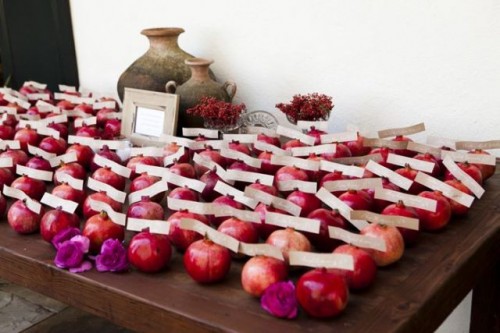 pomegranates holding wedding cards are a great idea for a fall or winter wedding, they can double as wedding favors