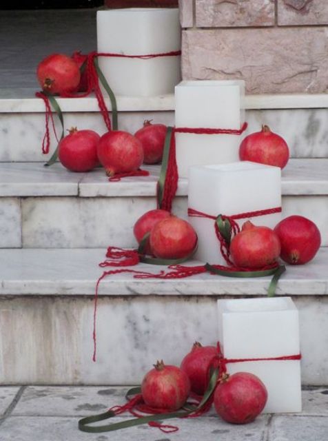 pillar candles and pomegranates are amazing for styling a staircase at any wedding, add red ribbon to the candles