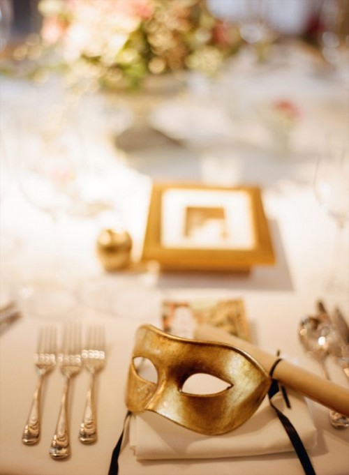 a gold mask is a lovely idea for a Venice wedding favor, and it may accent your wedding reception table