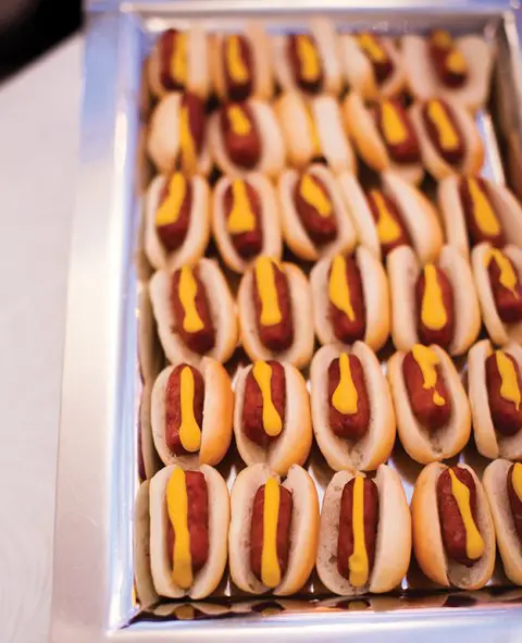 mini hot dogs with mustard are a taty and simple snack
