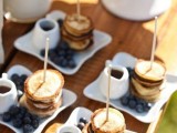 mini pancake stacks with blueberries and honey are amazing for brunch weddings or for those who have a sweet tooth