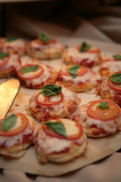 mini Margaret pizzas with cheese, tomatoes and herbs are a delicious snack