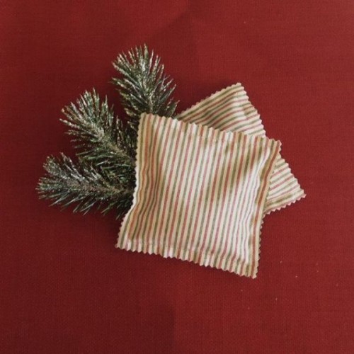snowy fir branches in striped pockets are simple and season-embracing wedding favors