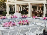 cool glam wedding backyard wedding tablescapes with bold pink floral centerpieces and neutral yet printed linens is a lovely space with a touch of color