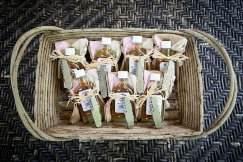 a basket with mini alcohol bottles with cards are a great idea for groomsmen gifts, it's a creative idea
